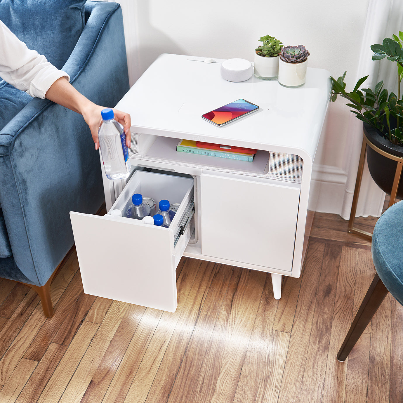 Person getting a cold beverage from their Sobro smart side table