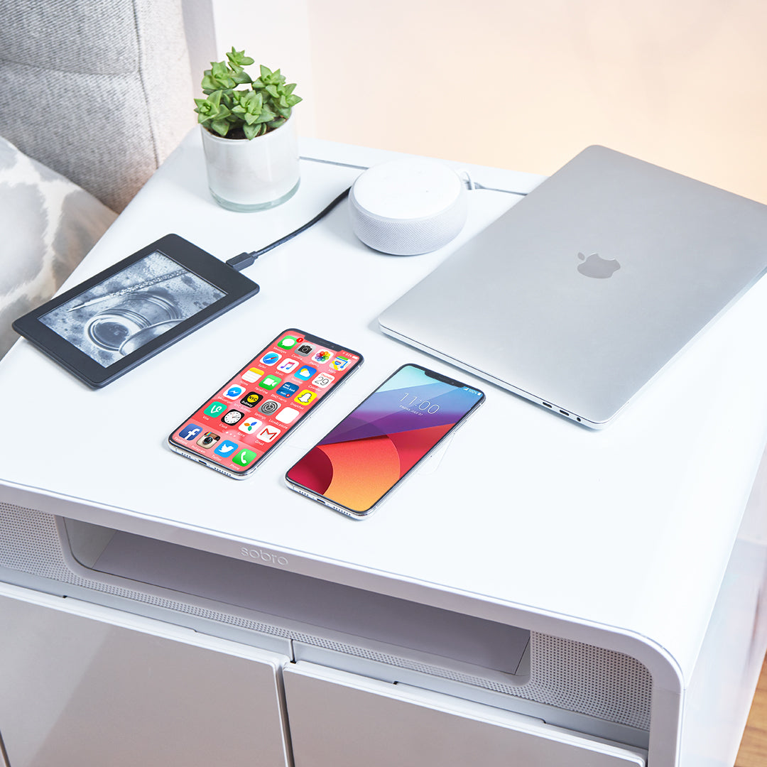 
                Laptop, tablet, 2 mobile phones charging from the USB charging ports in the Sobro side table. 
              